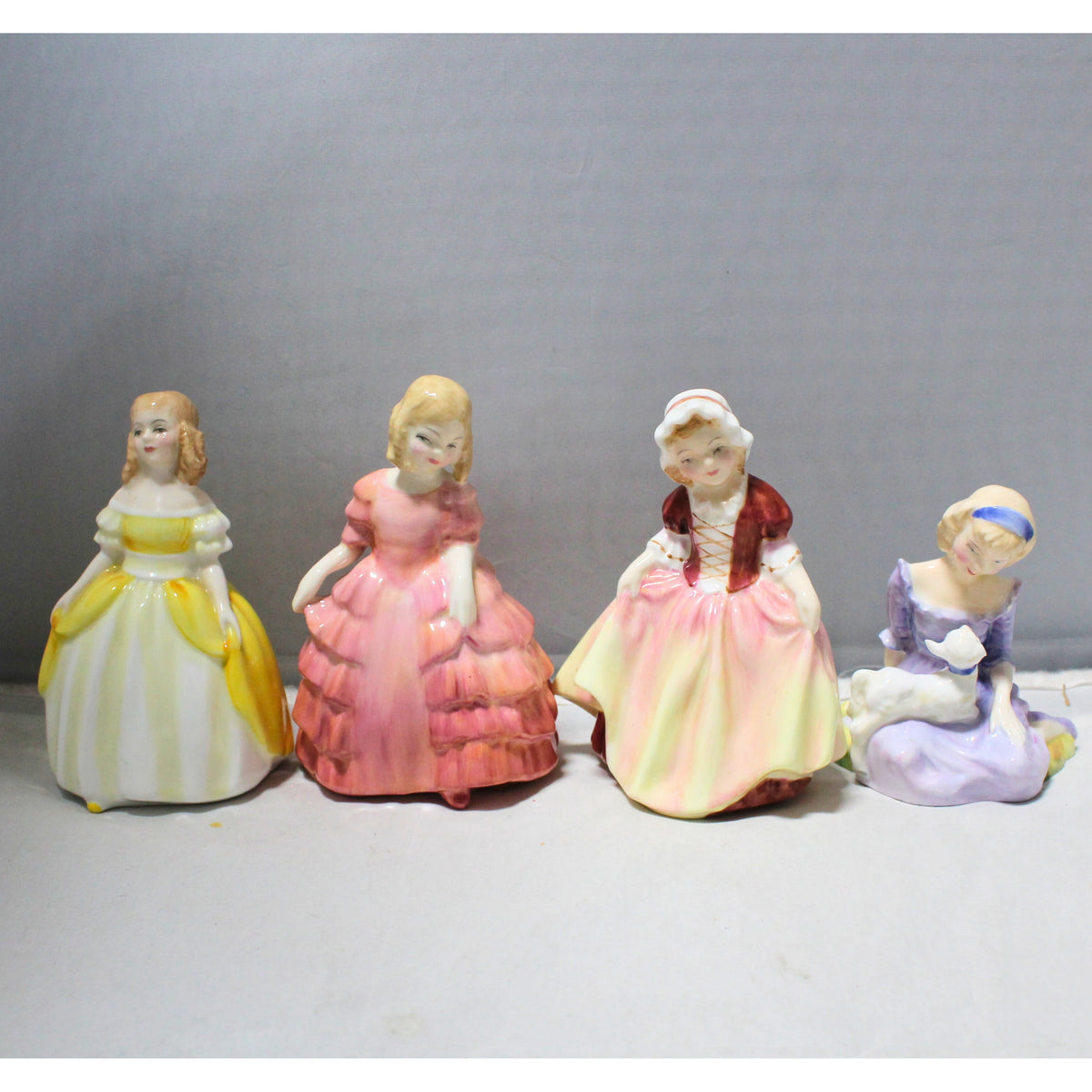 Lot of 4: Royal Doulton Figurines, Penny, Dinky Doo, Rose, and Mary Lot of 4: Royal Doulton Figurines, Penny, Dinky Doo, Rose, and Mary